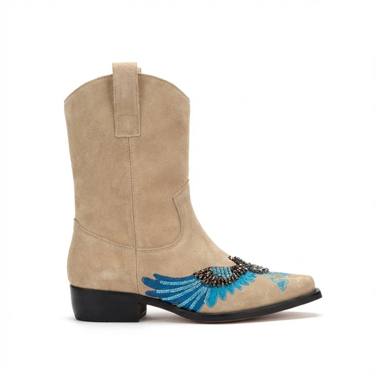 Beige suede Western ankle boot with blue turquoise embroidered eagle wing design on toe, pull strap, low black heel.
