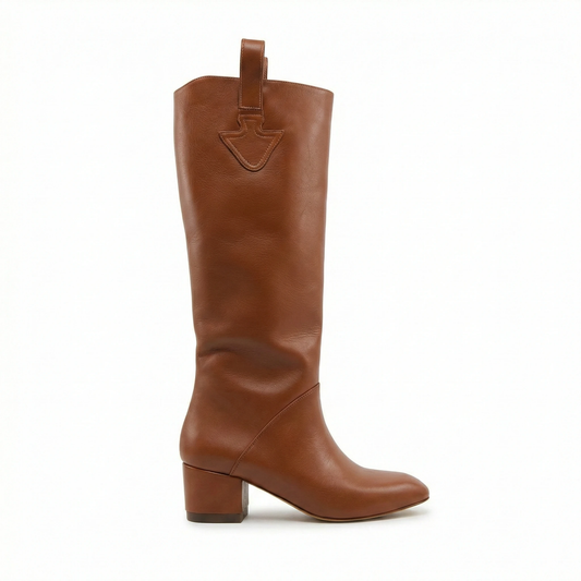 Cognac leather knee-high boot with rounded toe and mid-height block heel, top strap with shield-shaped stitch detail.