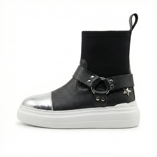 Black leather sock boot with silver toe cap, studded wrap strap, star charm, pull tab, and white platform sole.