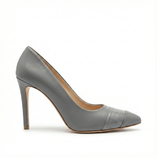 Grey leather pointed-toe pump with embossed cap toe detail, slender stiletto heel, tan sole and beige lining.