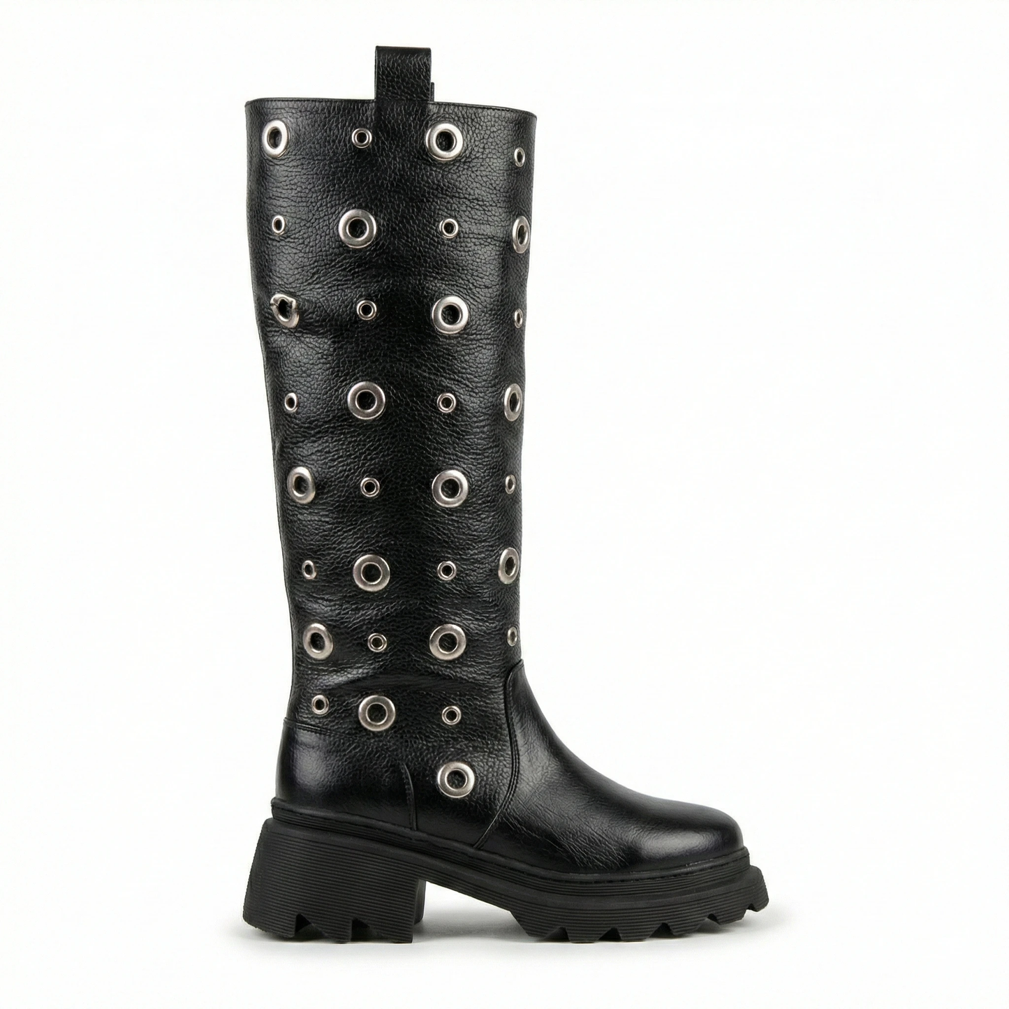 Black knee-high leather boot covered in silver grommets with a chunky platform sole and lug tread, pull tab at top.