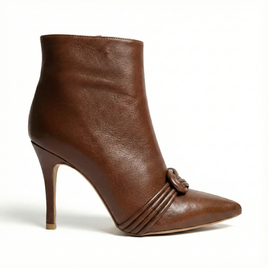 Cognac leather ankle boot with pointed toe, slim stiletto heel, and knotted strap detail across the vamp.