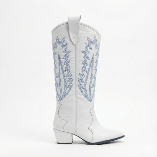 White leather Western boot with blue flame embroidery on the shaft, pull tab at top, pointed toe and stacked heel.