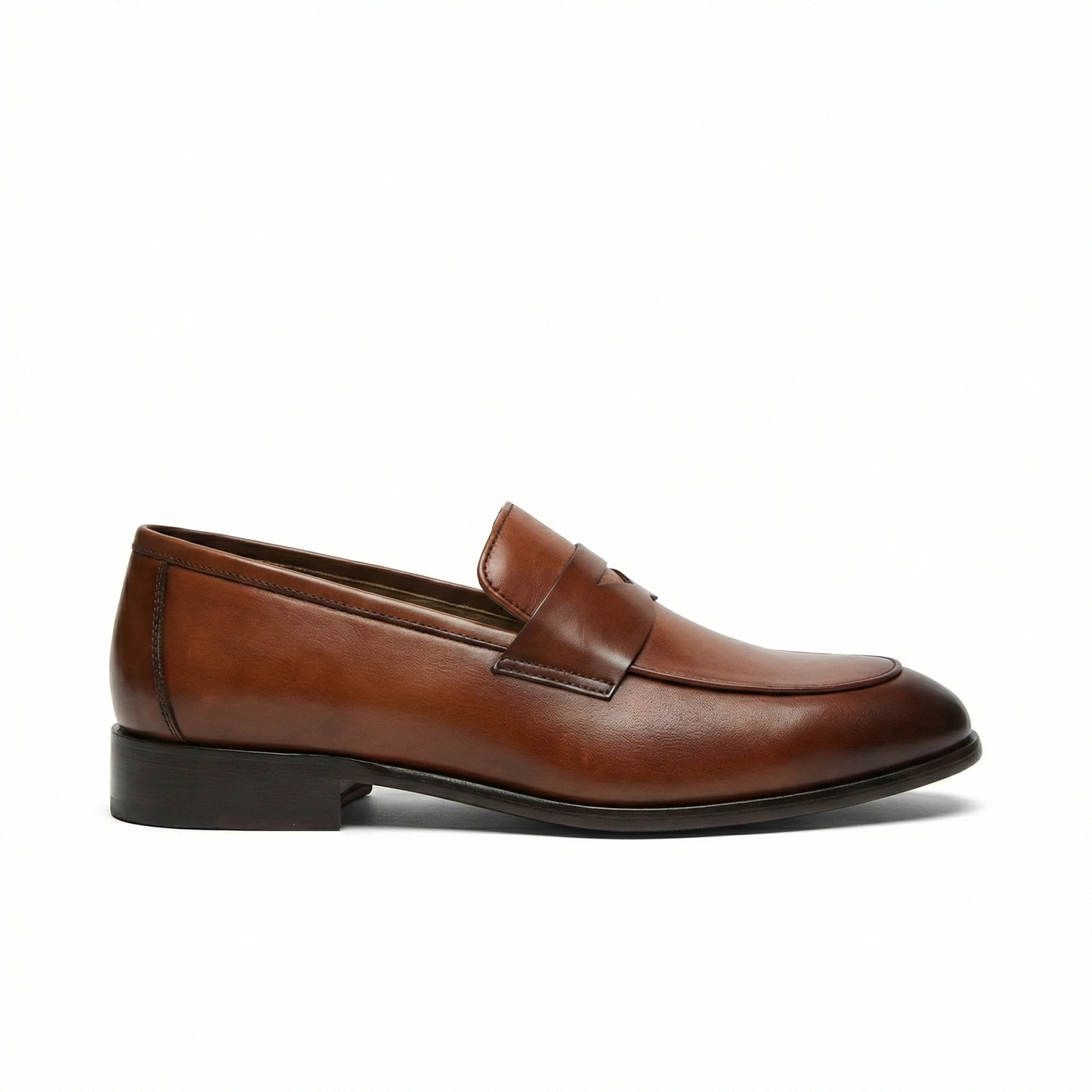 Cognac brown smooth leather penny loafer for men, side view with rounded toe, penny strap, black stacked heel.