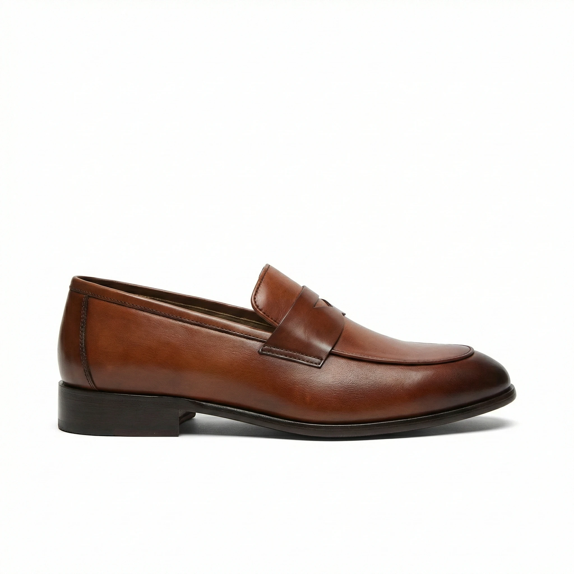 Cognac brown smooth leather penny loafer for men, side view with rounded toe, penny strap, black stacked heel.