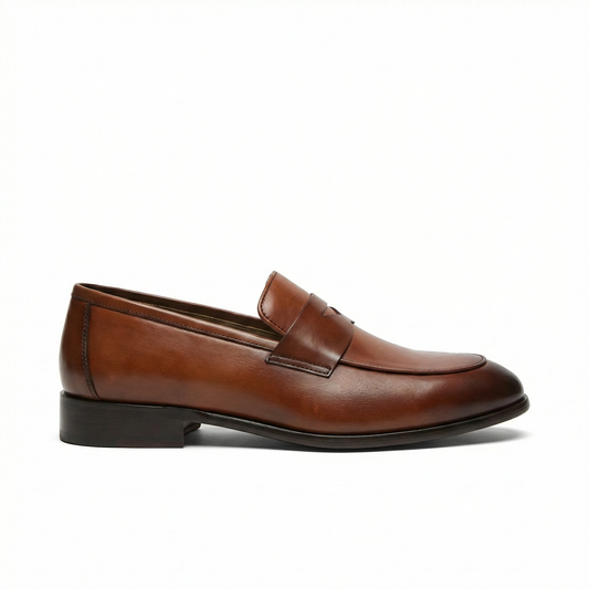 Cognac brown smooth leather penny loafer for men, side view with rounded toe, penny strap, black stacked heel.